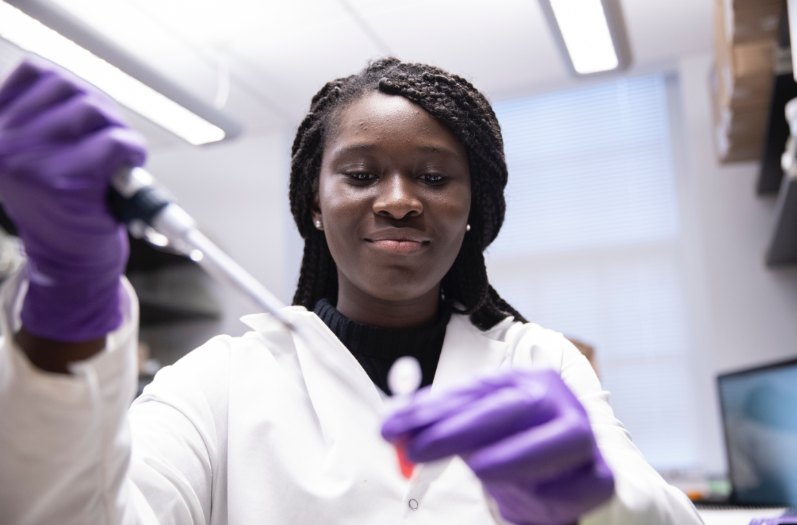 A woman running lab tests in a medical office.